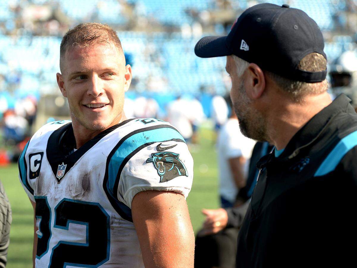 Carolina Panthers running back Christian McCaffrey (left) and then-head coach Matt Rhule smile after the team’s 19-14 victory over the New York Jets at Bank of America Stadium in Charlotte on Sunday, Sept. 12, 2021.