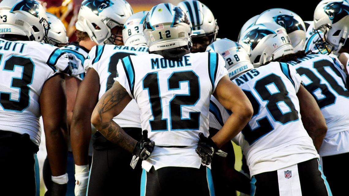Carolina Panthers wide receiver D.J. Moore (12) and his teammates huddle up during an NFL football game against the Washington Football Team, Sunday, Dec. 27, 2020 in Landover, Md. (AP Photo/Daniel Kucin Jr.)