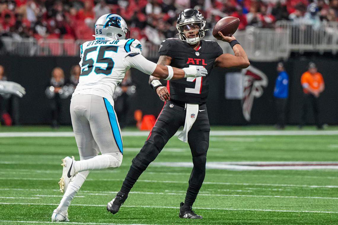 Jan 5, 2025; Atlanta, Georgia, USA; Atlanta Falcons quarterback Michael Penix Jr. (9) passes over Carolina Panthers defensive end Kenny Dyson Jr. (55) during the first quarter at Mercedes-Benz Stadium. Mandatory Credit: Dale Zanine-Imagn Images