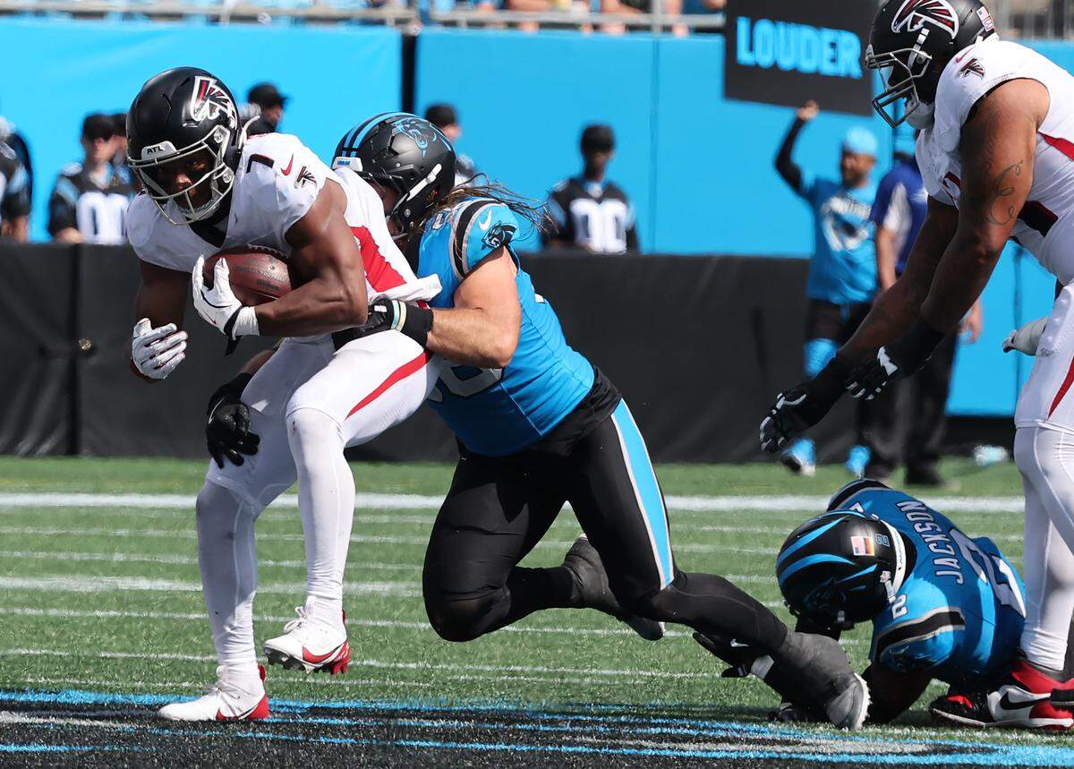 Carolina Panthers' Christian Rozeboom brings down Atlanta Falcons' Bijan Robinson at the Bank of America Stadium in Charlotte on Sunday, September 21, 2025.