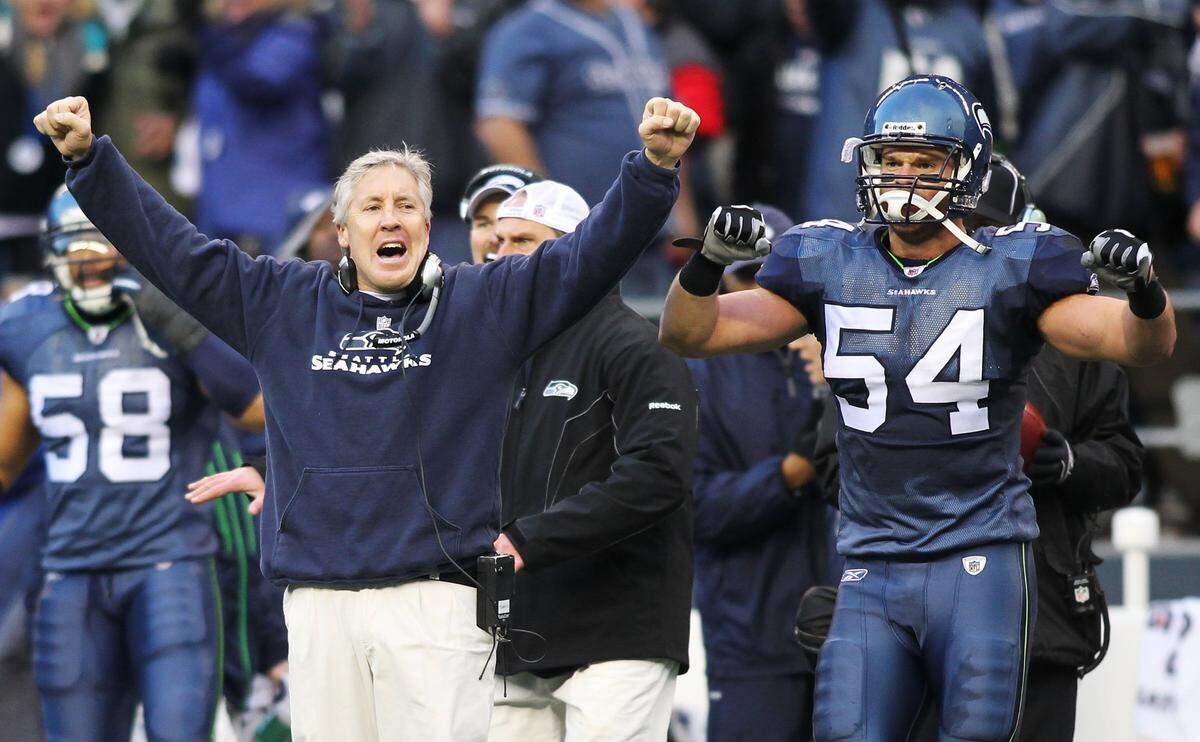 SEATTLE, WA - JANUARY 08: Head coach Pete Carroll and Will Herring #54 of the Seattle Seahawks celebrate a fourth down stop by the Seahawks in the third quarter against the New Orleans Saints during the 2011 NFC wild-card playoff game at Qwest Field on January 8, 2011 in Seattle, Washington. (Photo by Jonathan Ferrey/Getty Images) *** Local Caption *** Pete Carroll; Will Herring