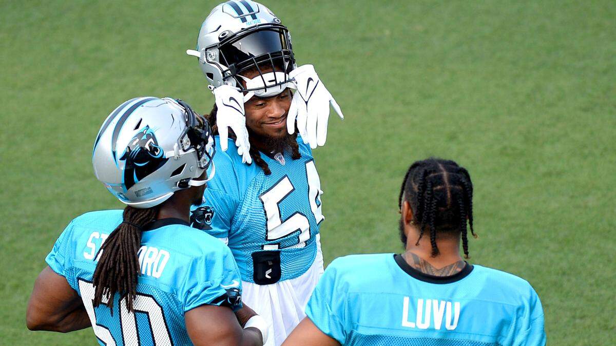Carolina Panthers linebacker Shaq Thompson, top, speaks with linebackers Julian Stanford, left and Frankie Luvu, right, during practice at Gibbs Stadium on Saturday. Thompson is expected to be the first banged-up Panthers player to return to full participation at training camp.