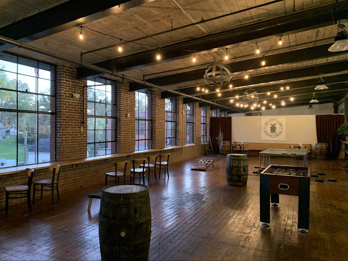 Customers have space to unwind on the “back porch” of Hot Box Next Level Kitchen inside Southern Strain Brewing in Concord.