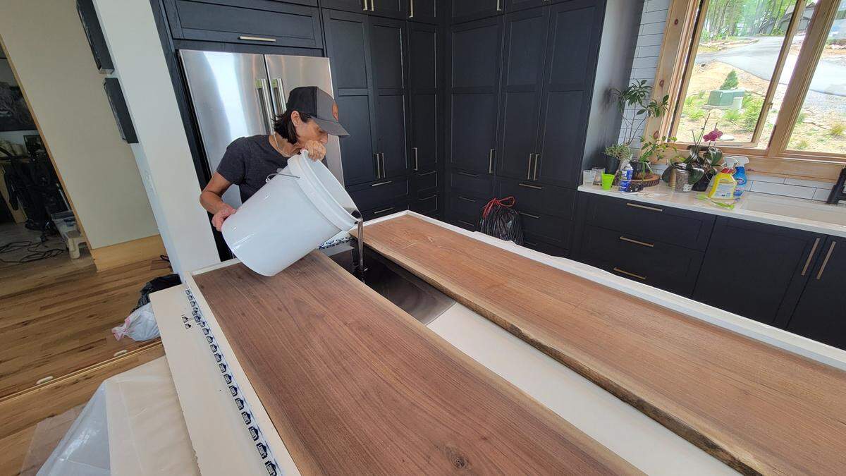 Says Danelle Martin, photographed in her home while doing work on her 10-foot black walnut and black resin dining table earlier this year: “Some people knit. Some people eat. Some people exercise. I like to work with wood.”