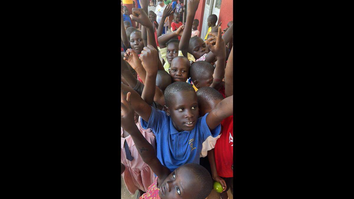 Children dance and play for the camera during a visit by Lake Norman resident Edward Jackson to Acres of Hope in Uganda.