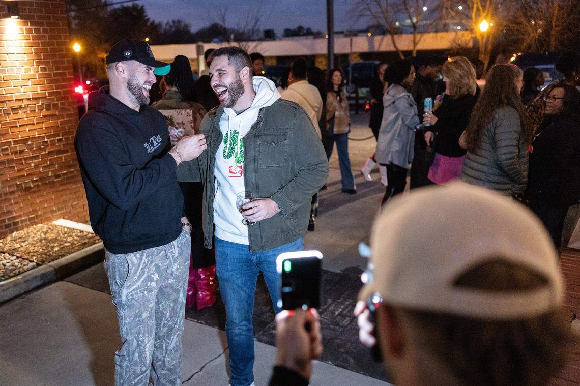 The 6-foot-9-inch, Tall Tour host, Tyler Bergantino, left, interviews another tall person during the Tall Tour event at Brewers At 4001 Yancey in Charlotte, N.C., on Saturday, December 6, 2025.