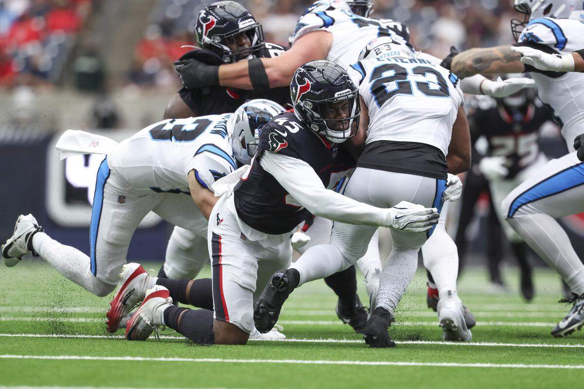 Houston Texans linebacker E.J. Speed (45) tackles Carolina Panthers running back Trevor Etienne (23) on a play during the second quarter at NRG Stadium. The Panthers ran only 46 total plays and had just 11 first downs.