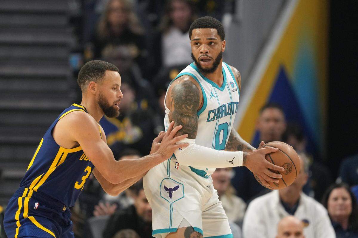 Charlotte Hornets forward Miles Bridges (0) handles the ball against Golden State Warriors guard Stephen Curry (left) during the first quarter at Chase Center.