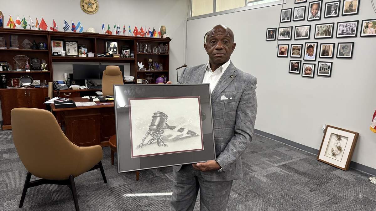 Sheriff Garry McFadden poses with artwork that one of the former teens at Jail North created. Jail North served as a juvenile detention center for years, and was thought successful by many. But McFadden closed it so he could move staff to the adult jail.