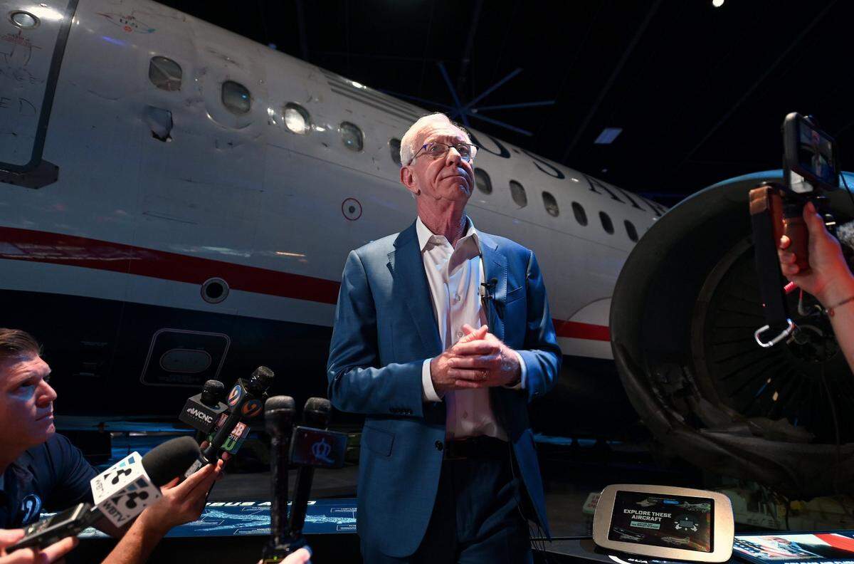 Former US Airways airline pilot Capt. C.B. “Sully” Sullenberger stands next to the jet he landed on the Hudson River in 2009. Sullenberger landed Flight 1549 on the Hudson River after both engines were disabled by a bird strike. All the passengers and crew survived the landing. Sullenberger and local dignitaries and business leaders were on hand at the Sullenberger Aviation Museum’s ribbon-cutting ceremony on Wednesday, May 29, 2024 in Charlotte, NC.