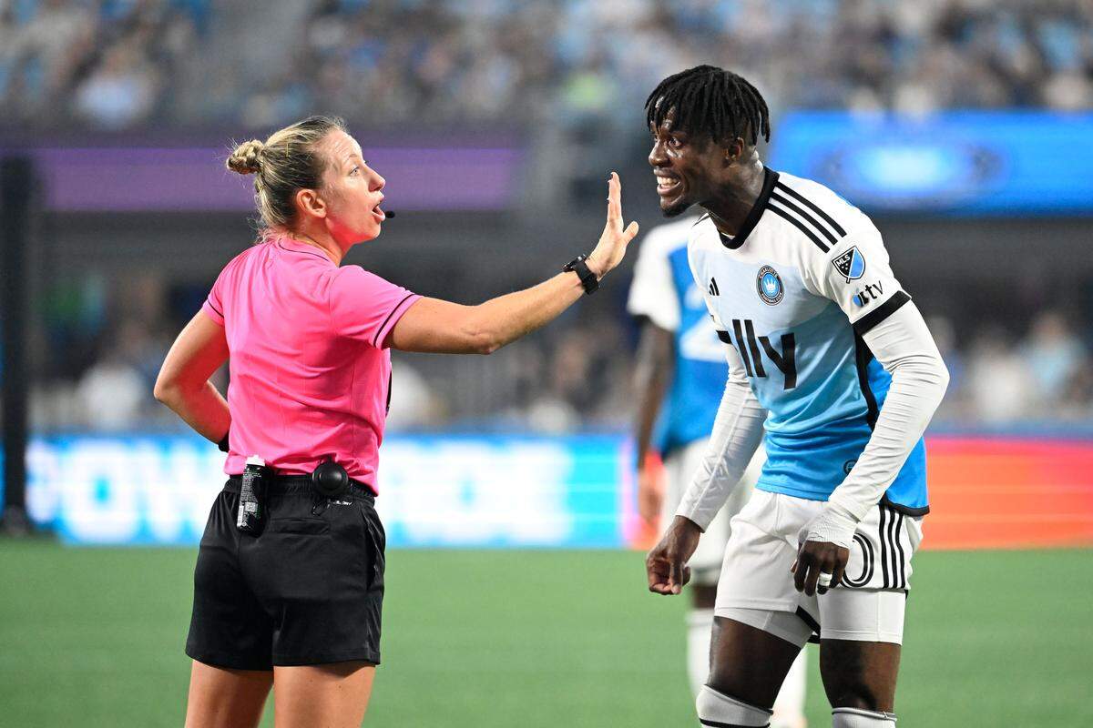 Referee Tori Penso gives a yellow card to Charlotte FC forward Wilfried Zaha (10) in the first half at Bank of America Stadium. 