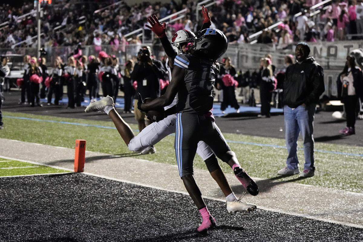 Hough wide receiver Jahmere Anderson (15) catches a touchdown with South Mecklenburg Mekhi Benson (10) in defence during the second half of a NCHSAA football game Friday, Oct. 17, 2025, in Cornelius, N.C.