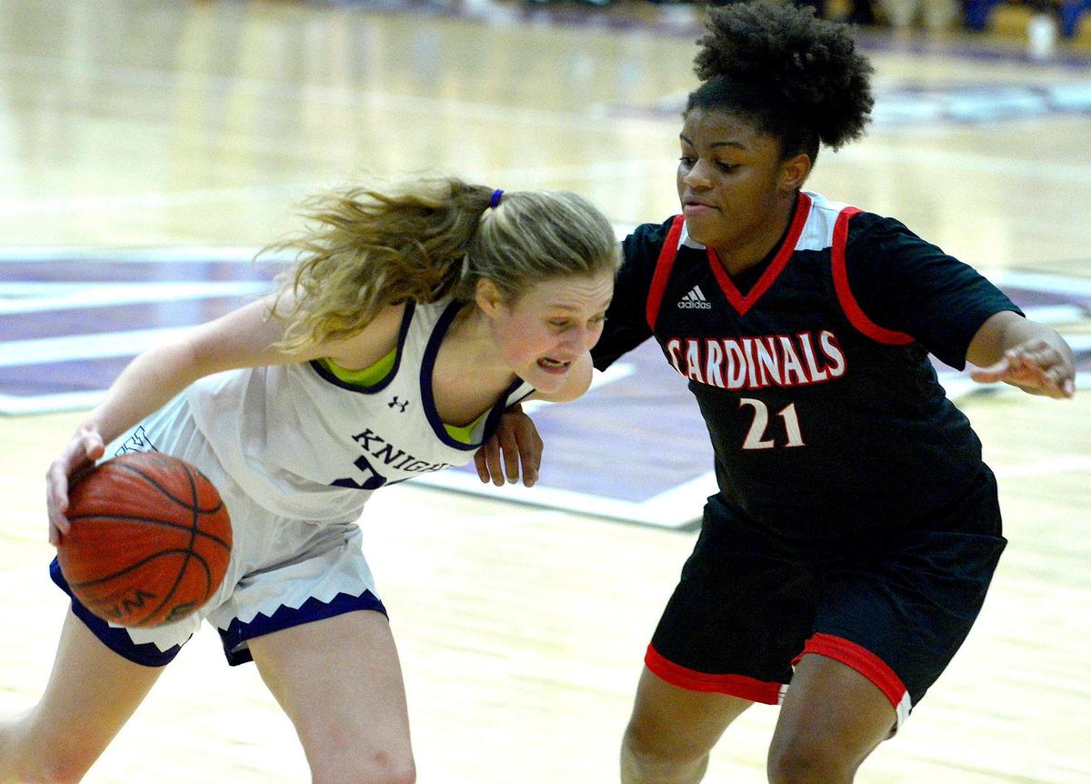 Ardrey Kell’s Evan Miller, left, battles Phillip O Berry’s Kendall Terry, right, as she drives along the baseline at Ardrey Kell High School on Thursday, February 28, 2019. Ardrey Kell won 49-41.