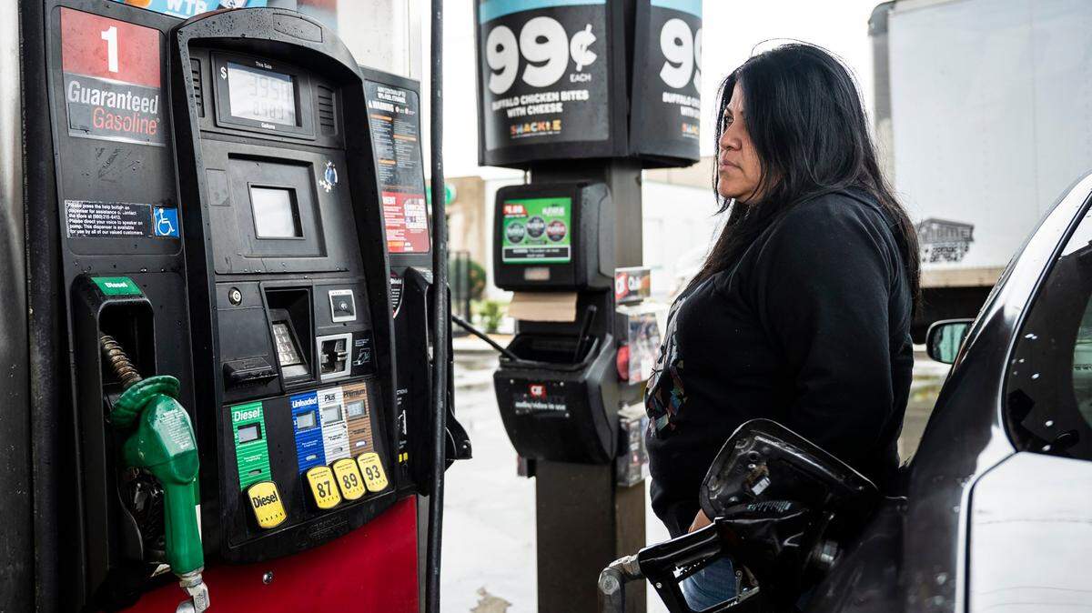 Saira Montesinos watches the screen as as she pumps gas at the QuikTrip on North Graham Street on Wednesday, March 9, 2022 in Charlotte. Montesinos is the manager at La Caseta, a restaurant in Camp North End, and regularly has to use her car to buy supplies for the business, I try to make less trips, but it depends on what the business needs.