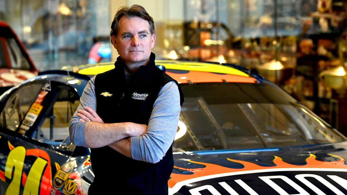 Former NASCAR driver and Hall of Fame member Jeff Gordon poses with one of his iconic No. 24 DuPont Chevrolets on Tuesday, March 21, 2023. Gordon is now the Vice-Chairman for Hendrick Motorsports in Concord, NC.