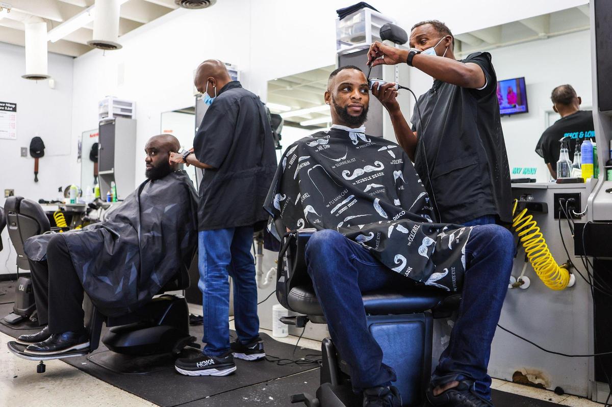 Anthony Greene, right, is a longtime barber in Charlotte. For the past 6 years, he’s worked at Anderton Barbershop off Statesville Avenue in North End. Greene is mostly welcoming of new growth and development, saying it could bring advocates to the neighborhood, including in the schools.