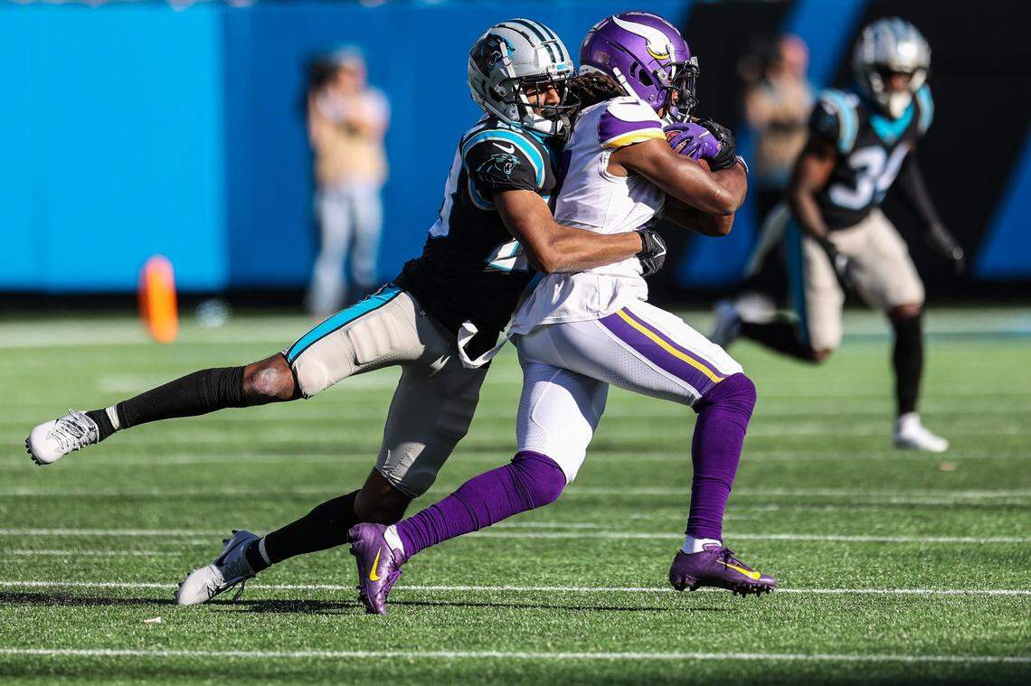 Panthers cornerback Keith Taylor, left, hangs onto Vikings wide receiver K.J. Osborn during the game at Bank of America Stadium on Sunday, October 17, 2021 in Charlotte, NC.