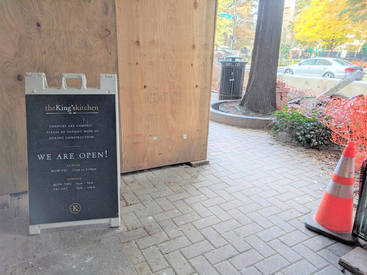 Some businesses on Trade Street have signs out front announcing, “We are open!,” such as at The King’s Kitchen saying “Please be patient with us during construction.”