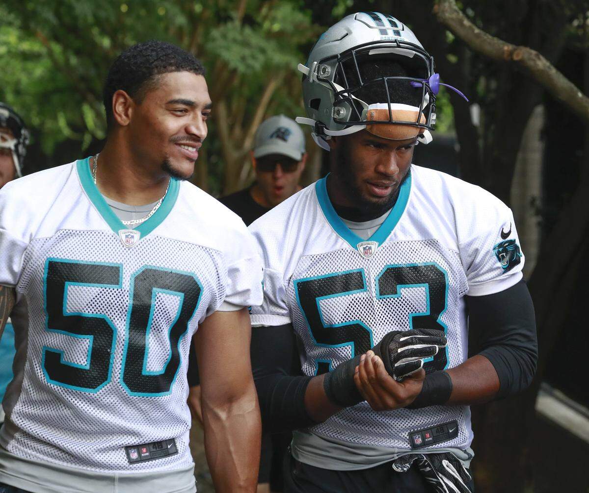 Panthers rookies Christian Miller (50) and Brian Burns walk to practice Monday as the team opens its final week of organized team activities in Charlotte.