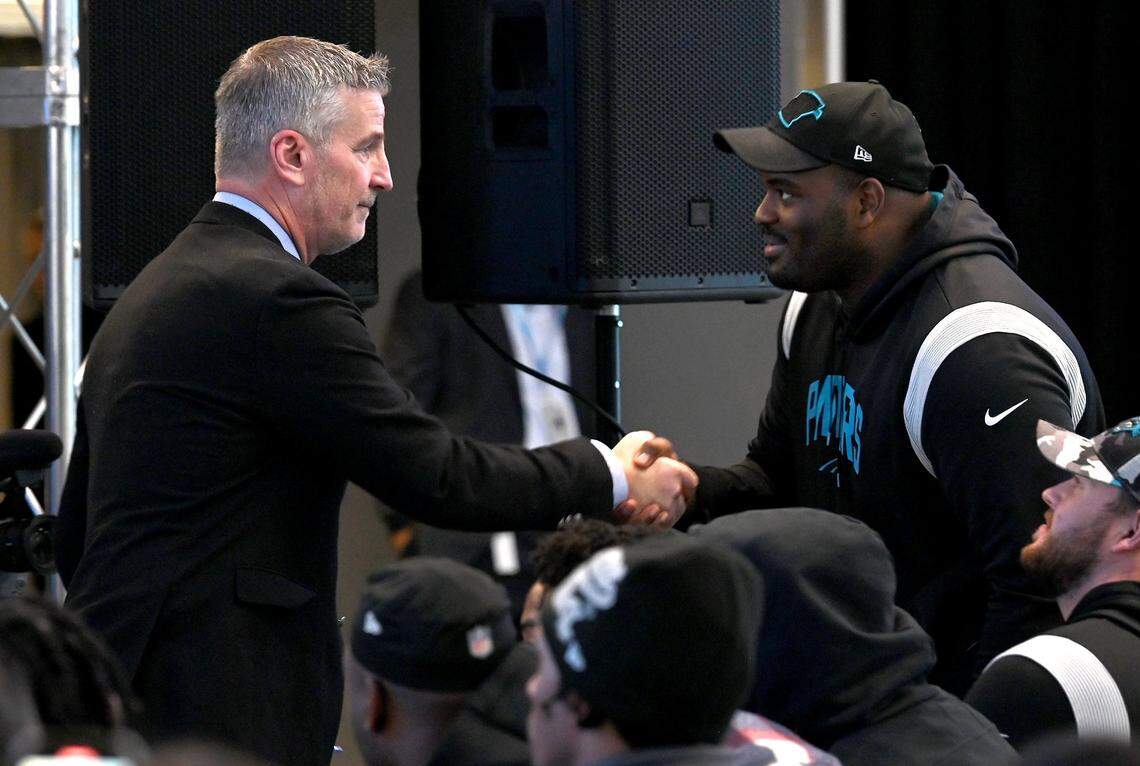 New Carolina Panthers head coach Frank Reich (left) said coaching is only 10-20% of the equation as to how successful a team is. The other 80-90%, Reich said, is how good your players are. Here Reich shakes hands with Carolina offensive tackle Taylor Moton during his introductory press conference on Jan. 31.