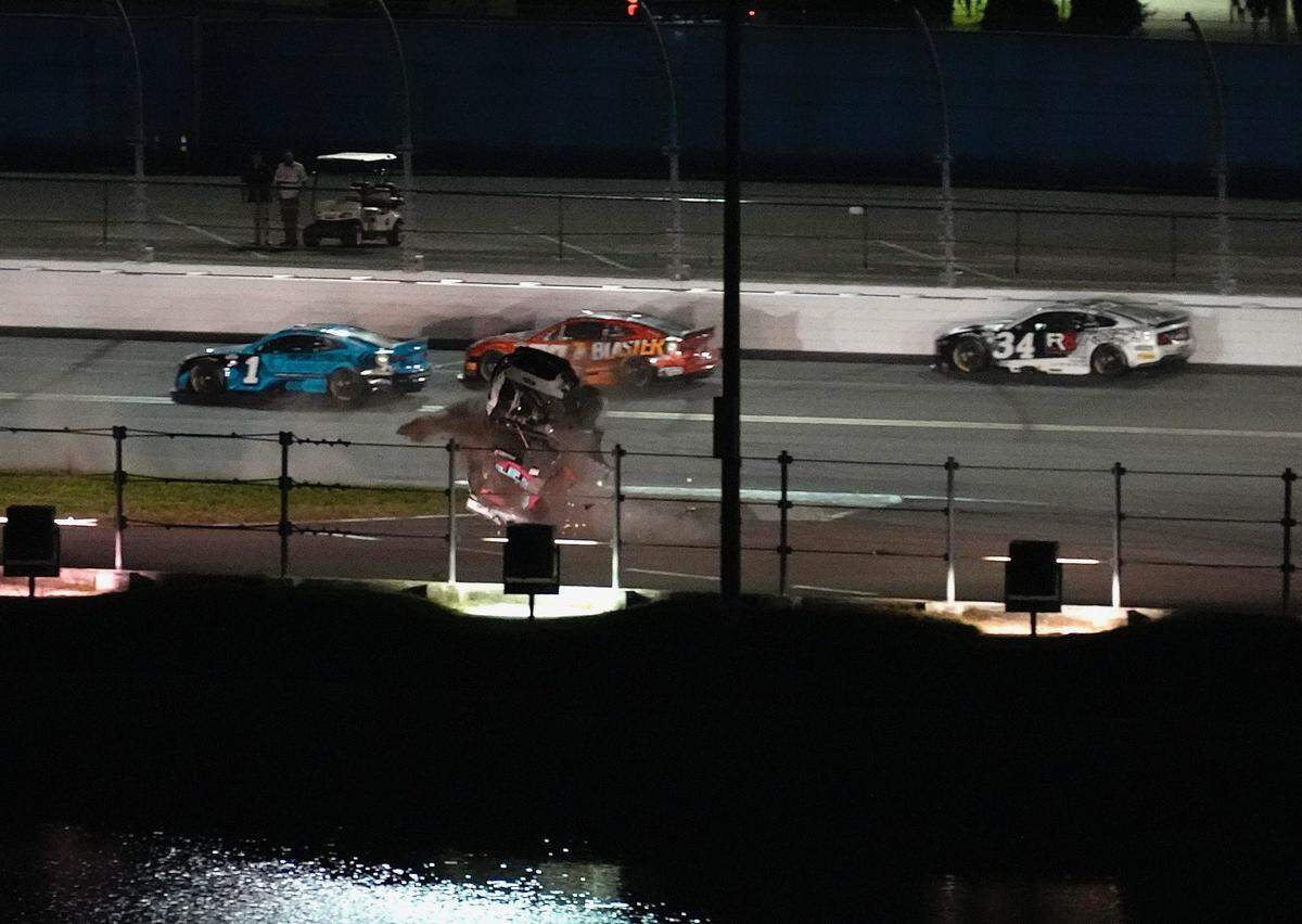 Ryan Preece flips through the grass on the backstretch after spinning out in the closing laps of the Coke Zero Sugar 400 on Saturday.