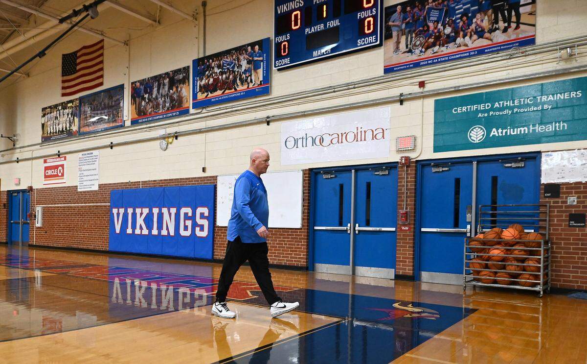 North Meck Vikings head basketball coach Duane Lewis walks off the court to talk with his team in the locker room following practice on Wednesday, November 5, 2025. Lewis has won four NCHSAA championships in his career at the school. The 2025 North Meck boys basketball team is ranked No.1 in the preseason sweet 16.