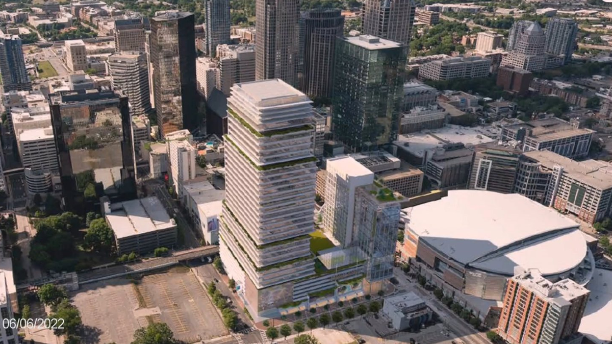 A high-rise building that would contain a practice facility for the Charlotte Hornets stands next to the Spectrum Center in this rendering presented to city officials on Monday.