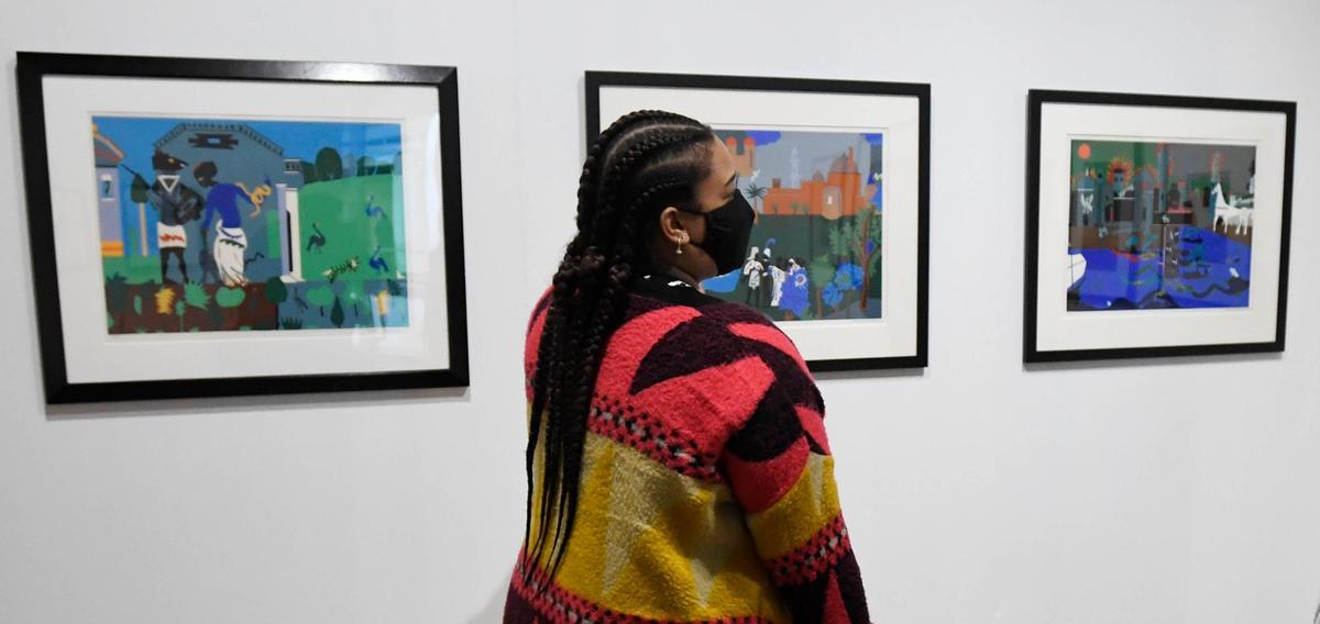 Tia Warren, visitor experience associate and docent lead at the Harvey B. Gantt Center for African-American Arts + Culture discusses Romare Bearden pieces that are part of the “Vision & Spirit: African American Art” exhibit from the Bank of America collection on display through July 31.