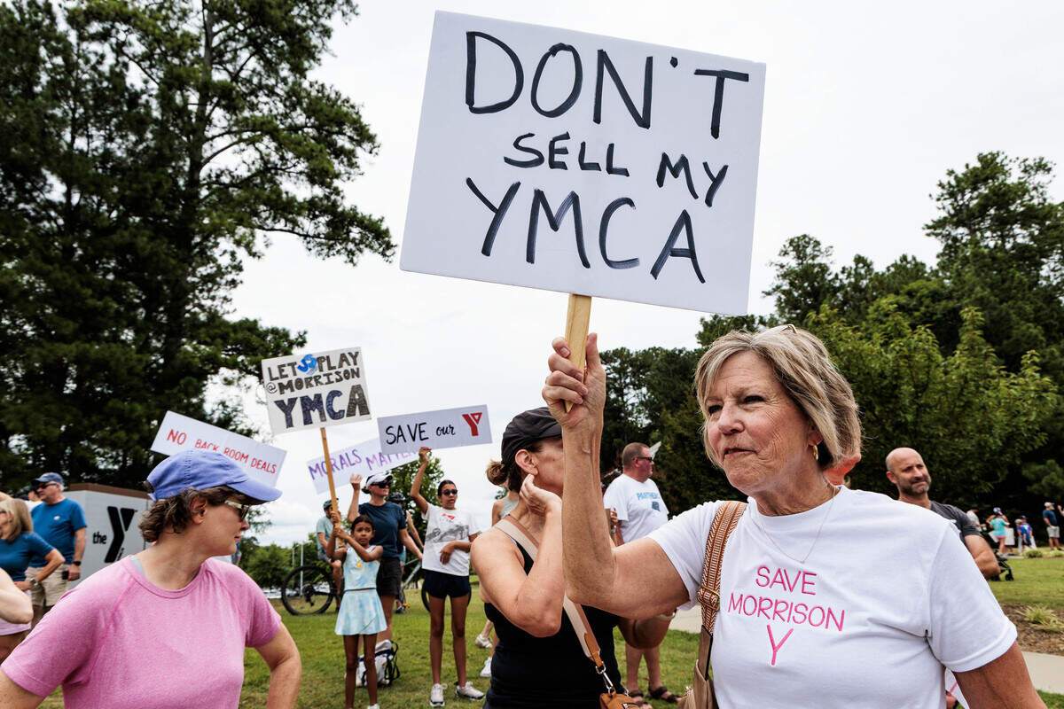 Protesters sport custom t-shirts and signs expressing their opposition to the planned sale of the Morrison Family YMCA campus in Ballantyne to Moments of Hope Church on Sunday, July 12, 2026.