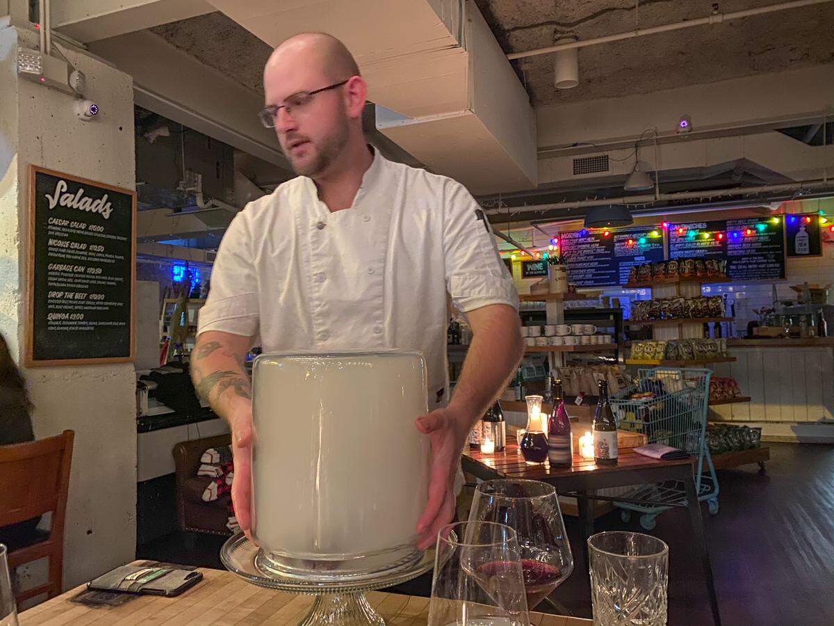 Chef Samuel Hart prepares to reveal the next course at a recent Anomaly pop-up dinner.