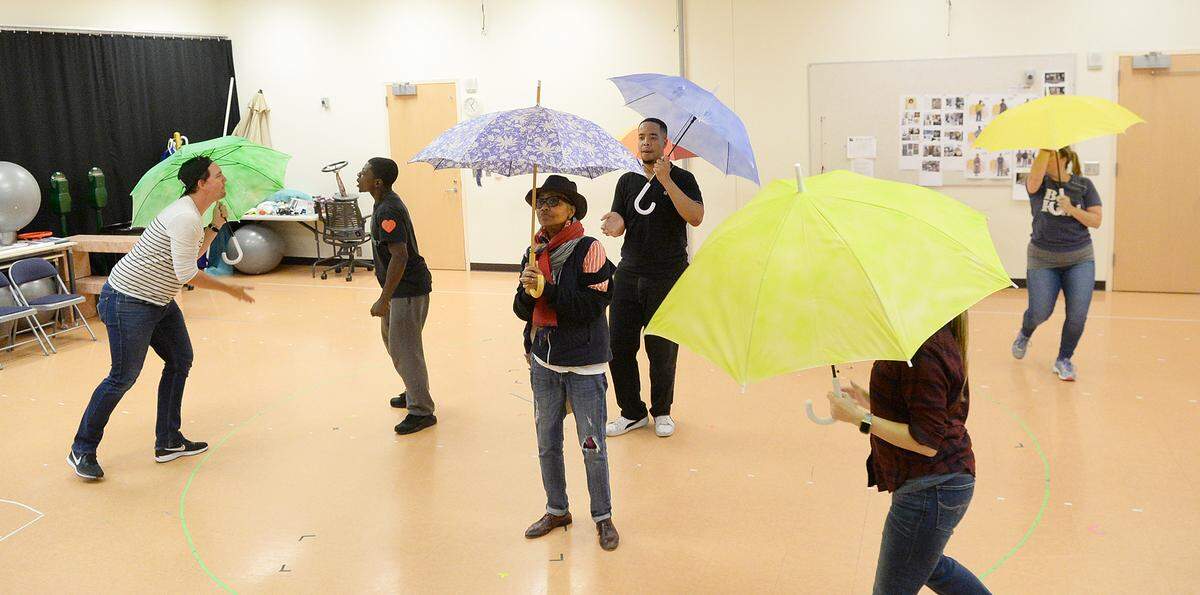 Nana (Corlis Hayes, center) and other cast members rehearse the “Last Stop on Market Street.”