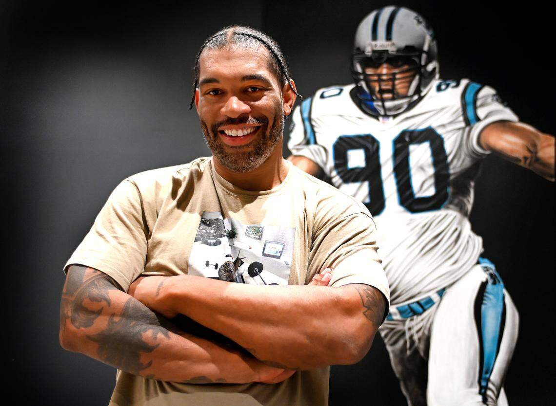 Former Carolina Panthers defensive end Julius Peppers at his home in Coral Gables, Fla., in front of a painting of himself in his #90 Panthers uniform. Peppers will be inducted into the Pro Football Hall of Fame on Aug. 3.