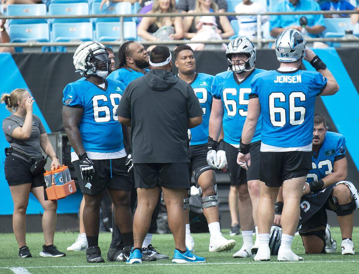 Carolina Panthers assistant offensive line coach Keli’i Kekuewa speaks to the offensive line during training camp practice at Bank of America Stadium on Saturday, July 27, 2024 as part of the annual Back Together Saturday event.