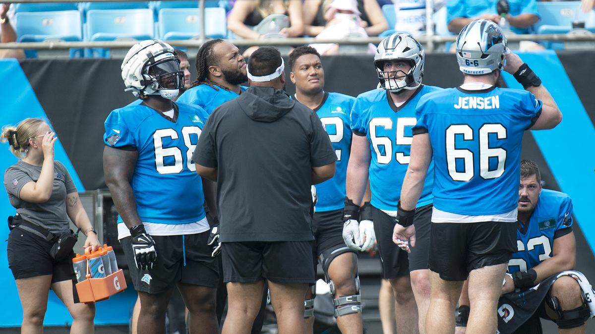 Panthers offensive linemen, including #68, Damien Lewis, took a brief break Saturday during practice. Fans celebrated the return of Panthers’ football during practice at Bank of America Stadium on Saturday, July 27, 2024 as part of the annual Back Together Saturday event. Practice, which began at 9:30 a.m., included performances by the Panthers entertainment group and activities for fans. Fans cheered on players like Bryce Young (#9), Xavier Legette (#17), Damien Lewis (#68) and head coach Dave Canales.