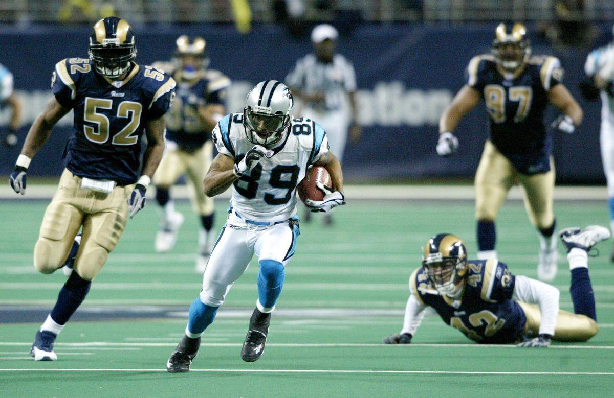 ST. LOUIS - JANUARY 10: Receiver Steve Smith #89 of the Carolina Panthers gets behind the St. Louis Rams defense to score the winning touchdown in overtime in the NFC Divisional Playoffs on January 10, 2004 at the Edward Jones Dome in St. Louis, Missouri. The Panthers defeated the Rams 29-23 to advance to the NFC Championship Game. (Photo by Doug Benc/Getty Images)
