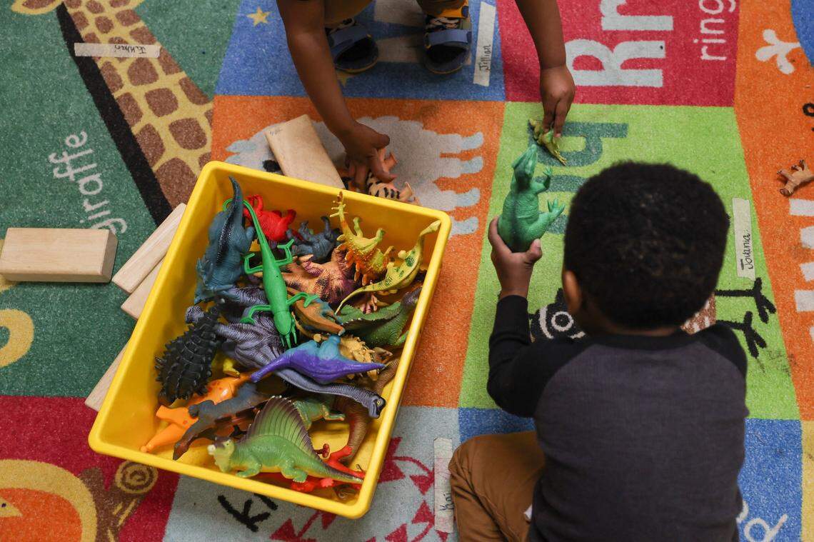 Kids play with dinosaurs at Lollipop Child Development Center on Monday, April 10, 2023.