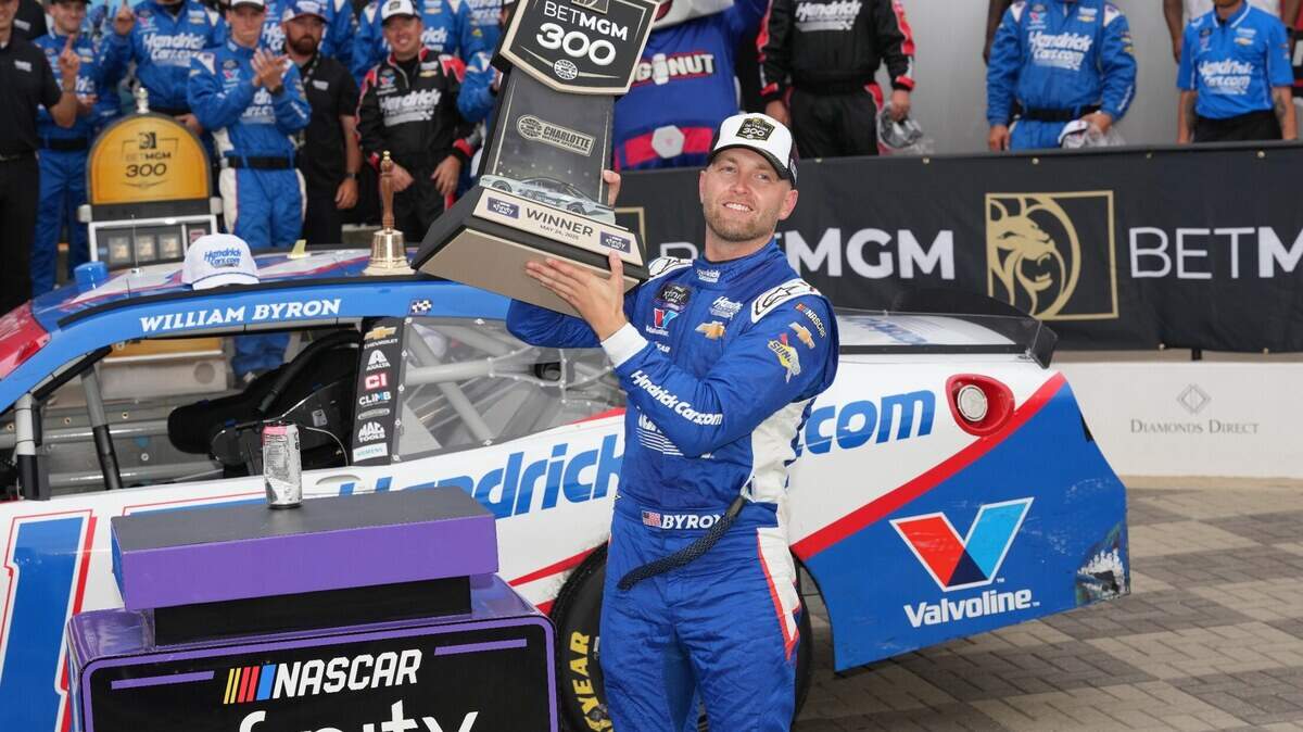 May 24, 2025; Concord, North Carolina, USA; William Byron (17) hoists the trophy after his win during the Bet MGM 300 at Charlotte Motor Speedway.