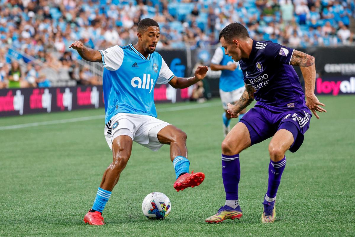 Charlotte FC midfielder McKinze Gaines, left, controls the ball against Orlando City defender Kyle Smith (24) in the first half in Charlotte, N.C., Sunday, Aug. 21, 2022.