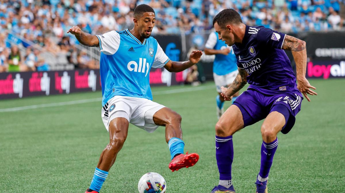 Charlotte FC midfielder McKinze Gaines, left, controls the ball against Orlando City defender Kyle Smith (24) in the first half in Charlotte, N.C., Sunday, Aug. 21, 2022.