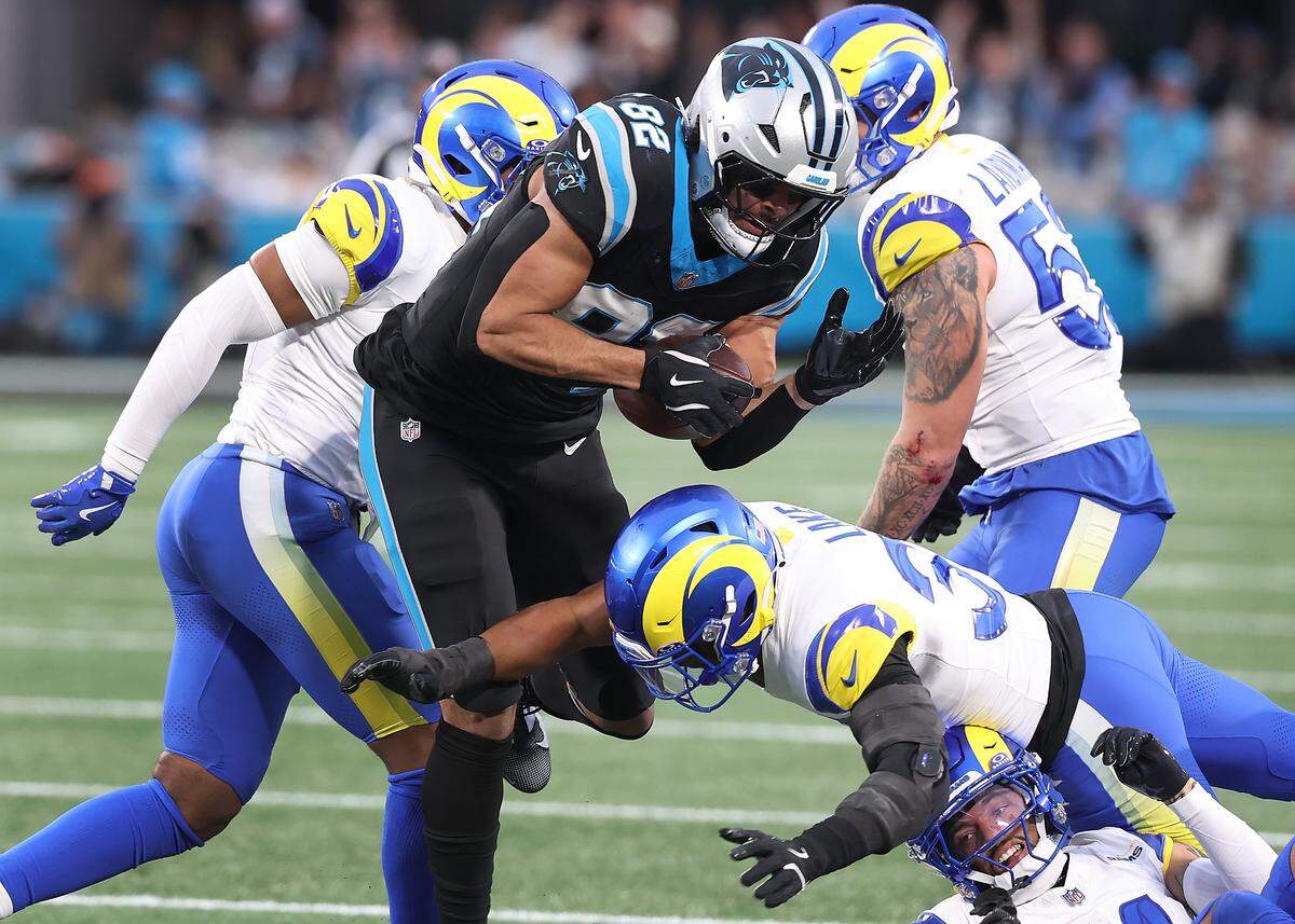 Carolina Panthers tight end Tommy Tremble fights for yardage as the Los Angeles Rams defense looks to make a tackle during action at Bank of America Stadium on Saturday, January 10, 2026. The Rams defeated the Panthers 34-31.