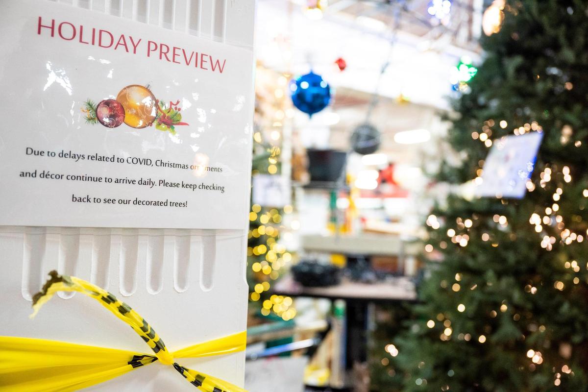 A sign at Blackhawk Hardware in Park Road Shopping Center in Charlotte telling shoppers about shipping delays is posted next to a Christmas display.