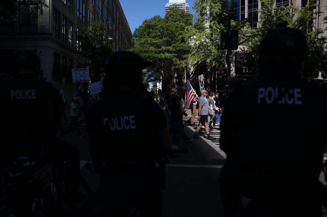 The ‘No Kings’ protest marches through uptown Charlotte as CMPD officers monitor on Saturday, Oct. 18, as part of a national rally against policies enacted by President Donald Trump.