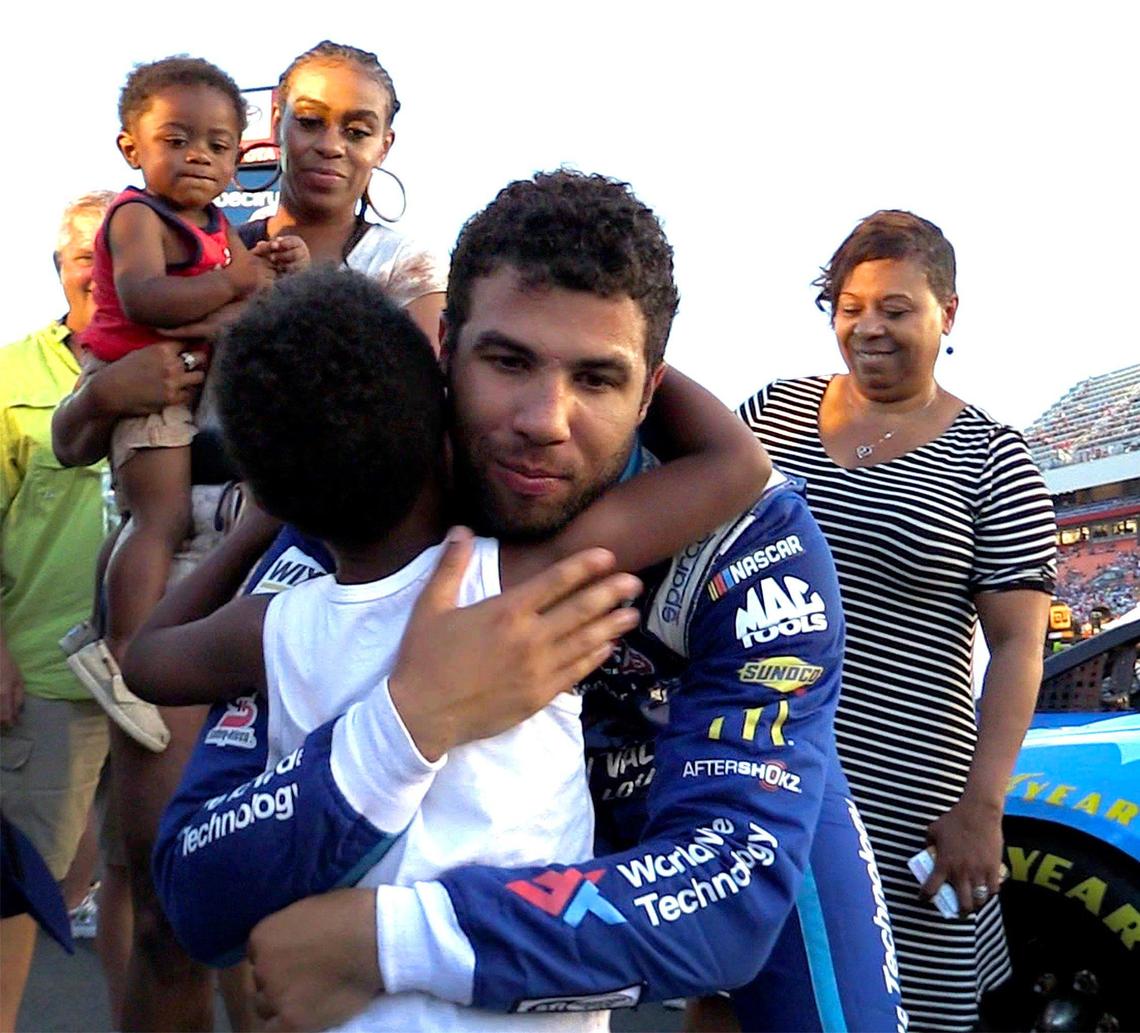 NASCAR driver Bubba Wallace hugs his nephew Brandon Smith before climbing into his car for the NASCAR All-Star Race at Charlotte Motor Speedway on May 18. Brandon’s mother, Brittany Smith, holds son Brixton while Wallace’s mother, Desiree, watches.