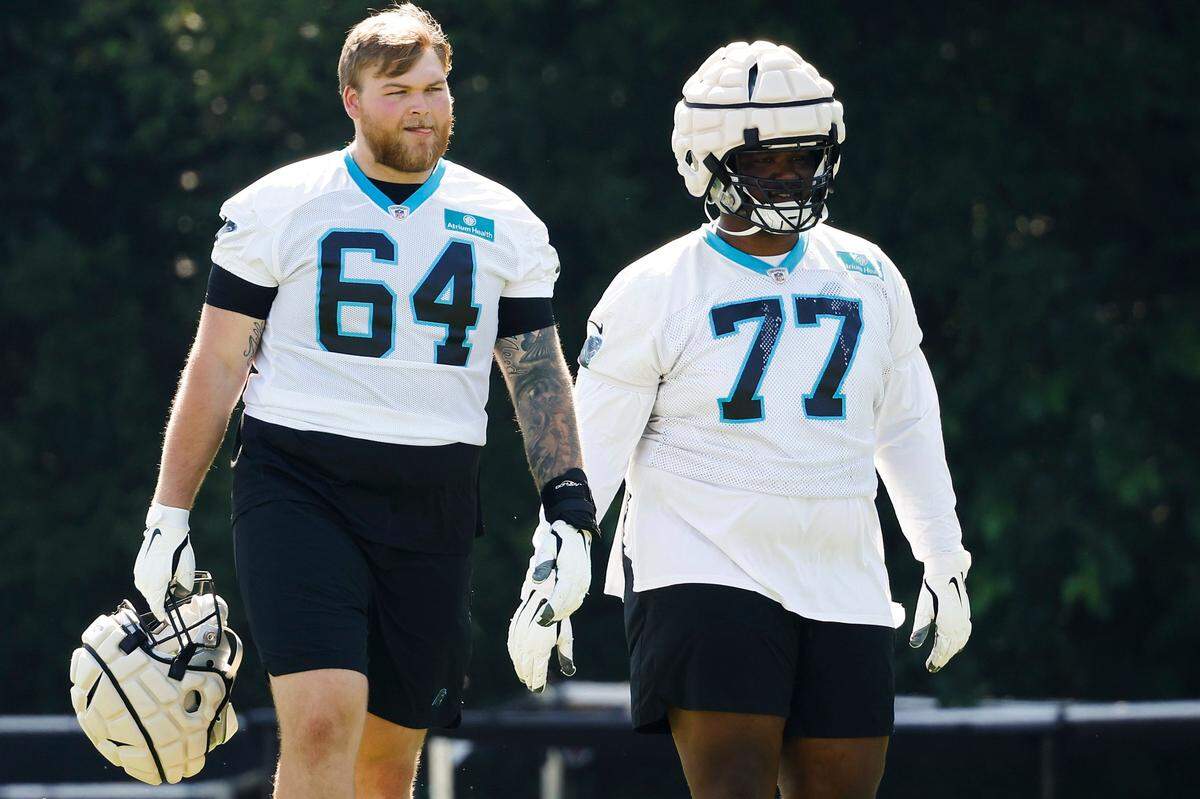 Carolina Panthers offensive lineman Cade Mays (64) and Carolina Panthers guard Deonte Brown (77) on the field during the teams training camp practice at Wofford College in Spartanburg, S.C., Thursday, July 28, 2022.