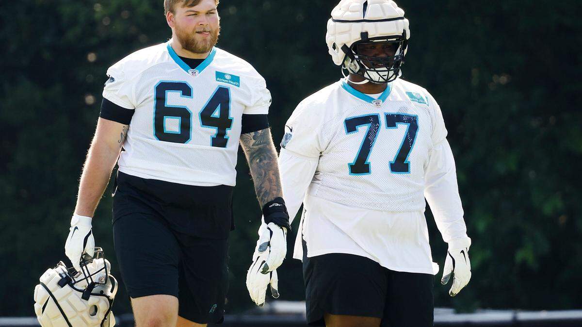 Carolina Panthers offensive lineman Cade Mays (64) and Carolina Panthers guard Deonte Brown (77) on the field during the teams training camp practice at Wofford College in Spartanburg, S.C., Thursday, July 28, 2022.
