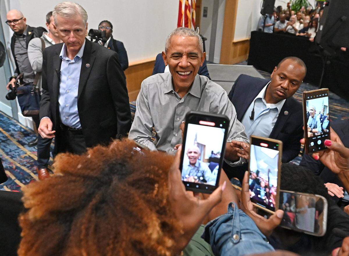 Former President Barack Obama shakes hands with well wishers in the overflow crowd area at the Charlotte Convention Center on Friday, October 25, 2024. The former president spoke to the crowd about the need to vote for Vice President Kamala Harris in the presidential race.