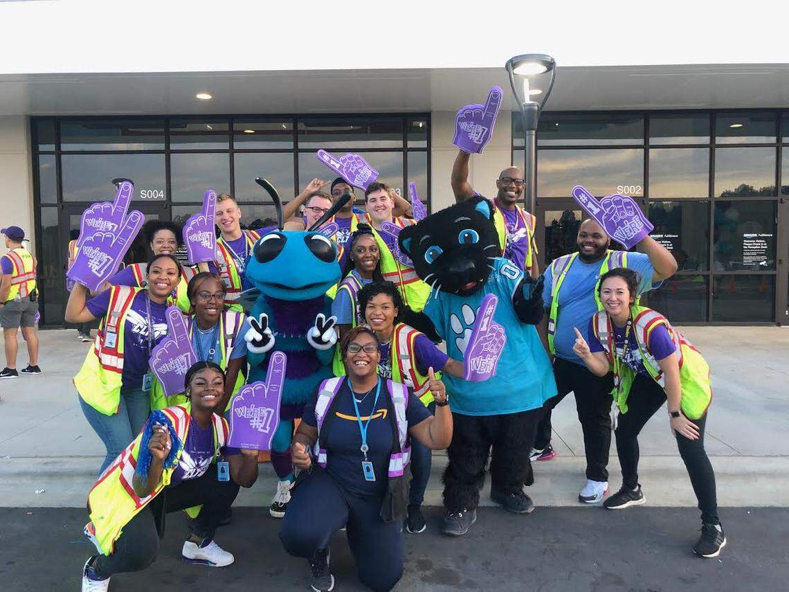 Amazon employees celebrated their first day at the Charlotte robotics fulfillment center with appearances from city sports mascots Sir Purr and Hugo the Hornet.
