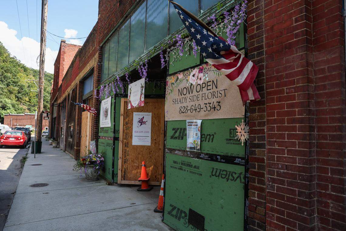 Shady Side Florist on Carolina Lane in downtown Marshall, NC is open, but still has plywood and structural boards covering areas that were destroyed by flooding.