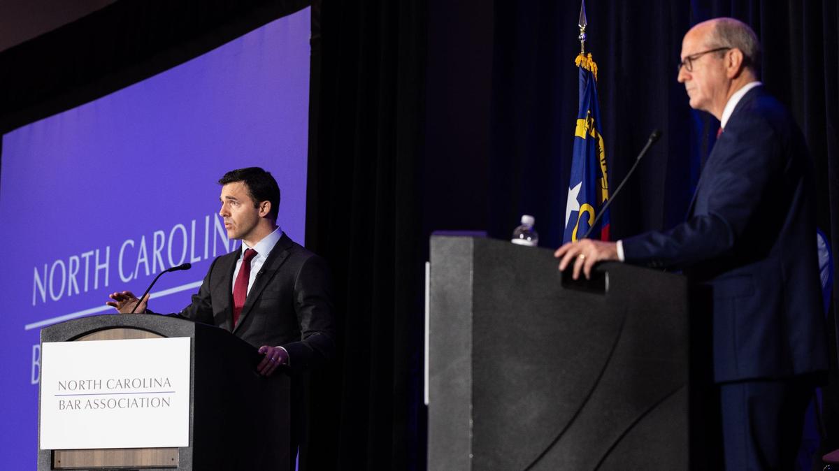 Jeff Jackson, left, debates Dan Bishop in the attorney general’s race at the Charlotte Convention Center on Friday, June 21, 2024.