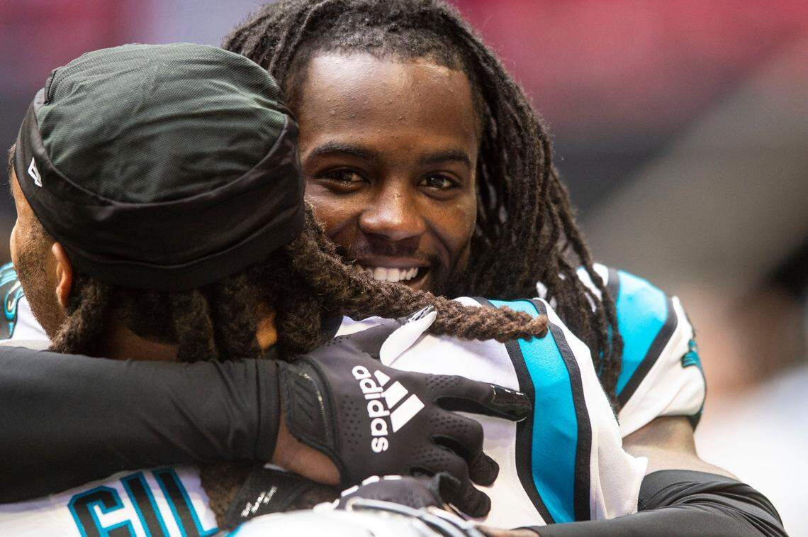 Panthers cornerback Donte Jackson hugs teammate Stephon Gilmore after Gilmore made an interception during the game against the Falcons at Mercedes-Benz Stadium on Sunday, October 31, 2021 in Atlanta, GA.